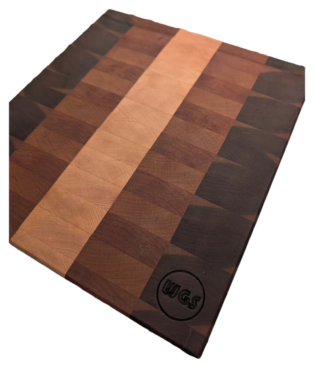End-grain cutting board in walnut, cherry and maple, with the maker's mark branded into one corner